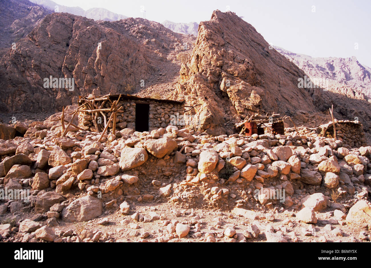 Deserted stone hut by track side in the Musandam mountains, probably a goat herders refuge or road workers refuge. Oman. Stock Photo
