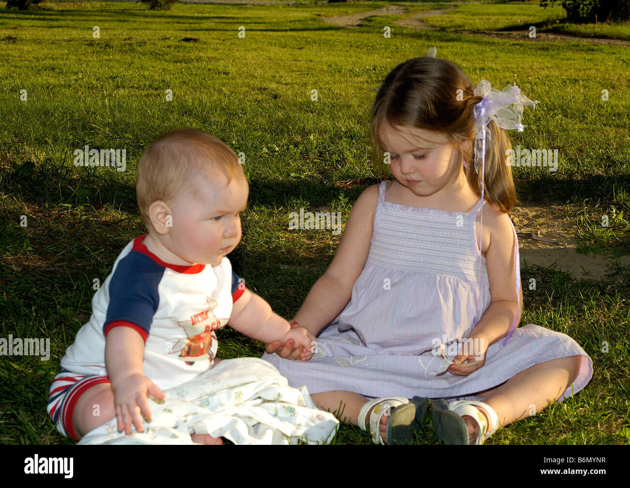 Little brother and sister holding hands Stock Photo - Alamy