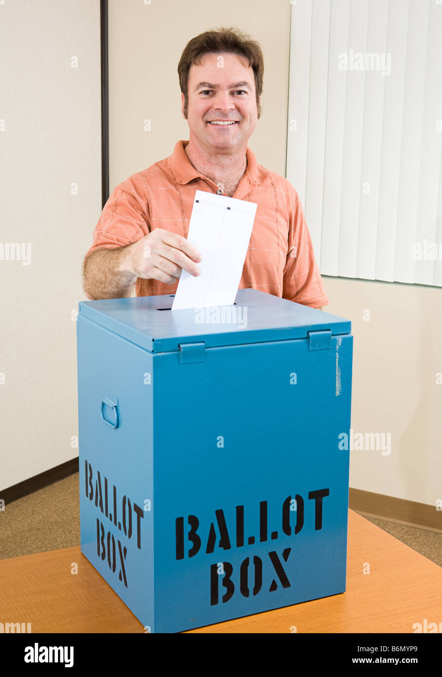 Middle aged caucasian man casting his ballot in the election Stock Photo