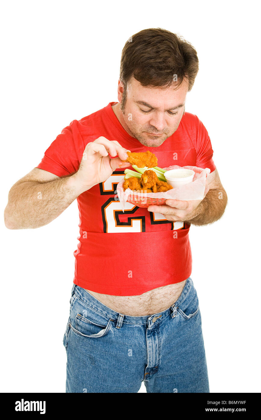 Overweight middle aged man eating greasy fast food chicken wings Isolated Stock Photo