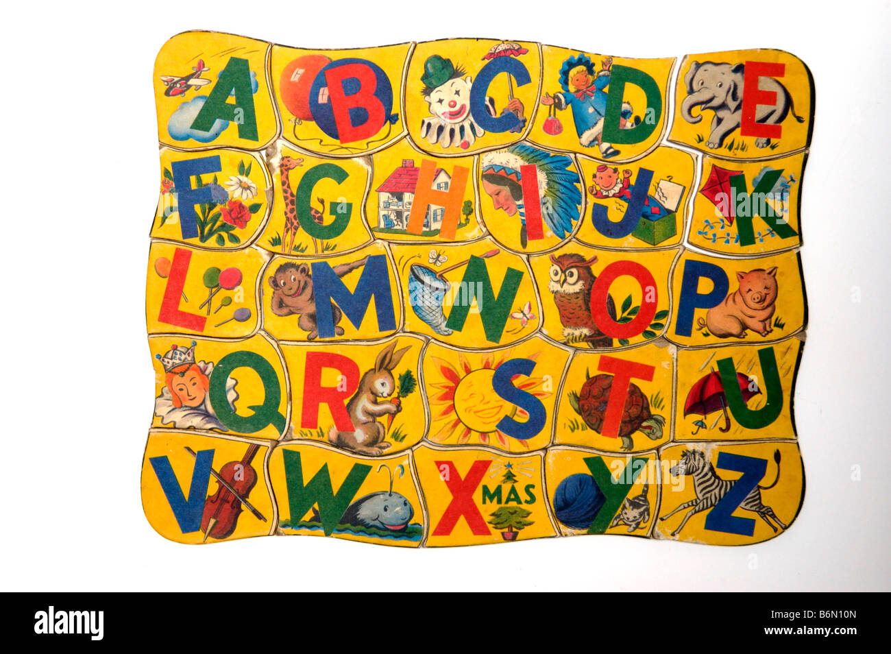 Vintage alphabet letter puzzle piece for children with the letter L and the picture of lollipops printed on it Stock Photo