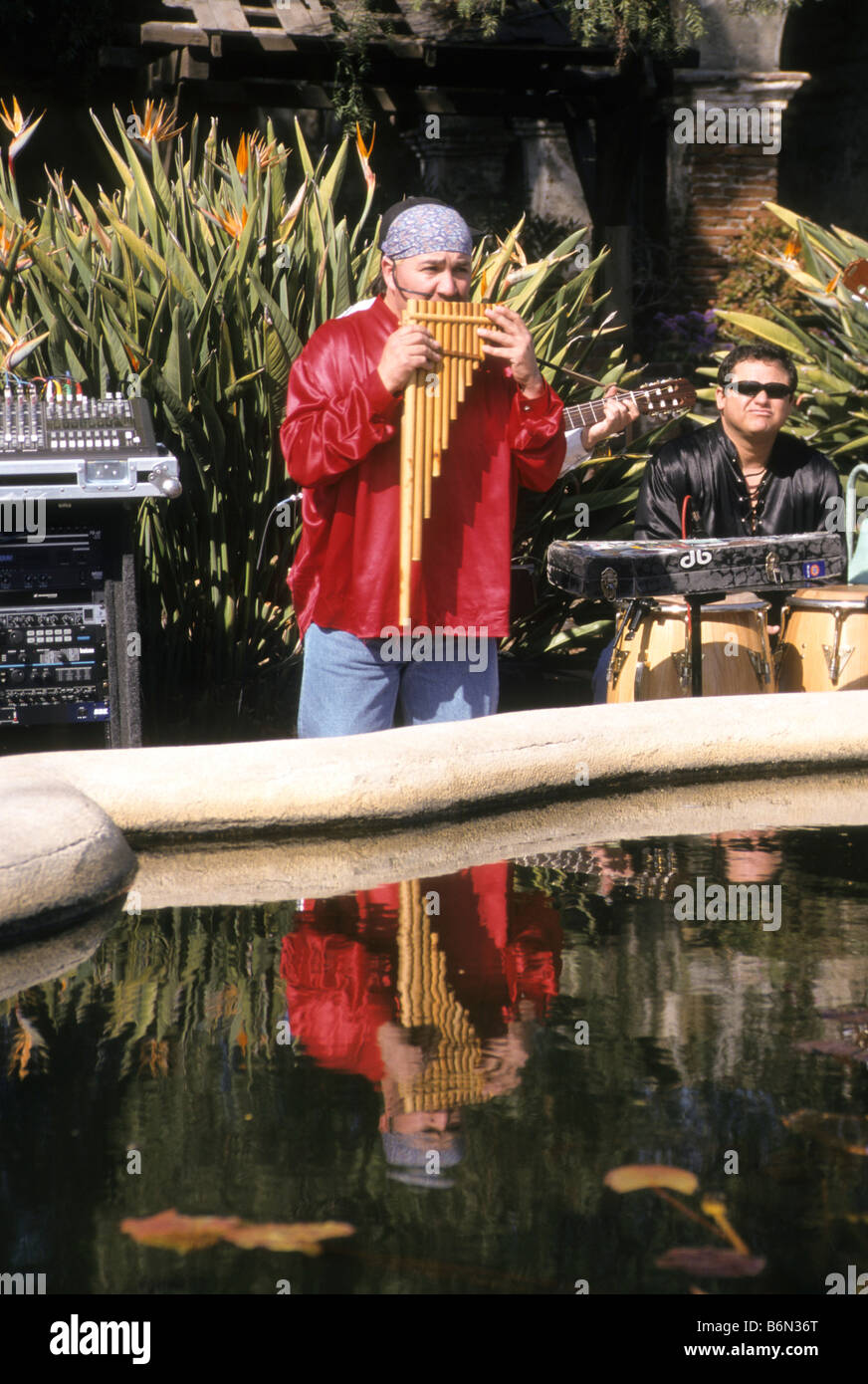 Man in traditional costume plays pan flute at Mission San Juan Capistrano, California Stock Photo