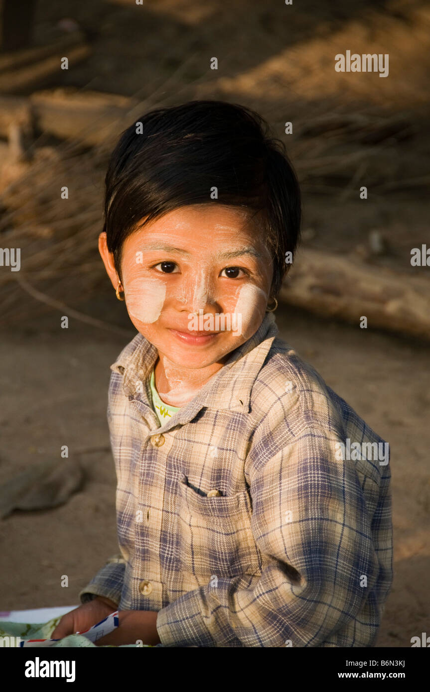 Burmese Karen girl smiling in morning sunlight in northern Thailand Stock Photo