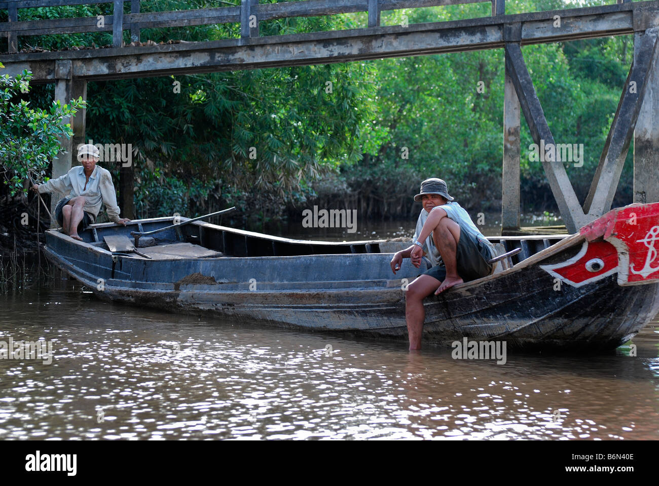Two men fishing in sampan, An Binh, Mekong Delta Vietnam Stock 