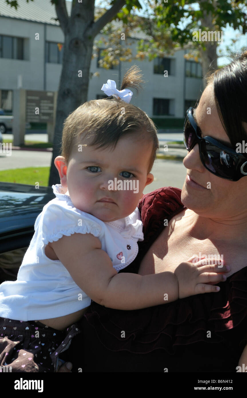 Baby girl in arms of mother Stock Photo