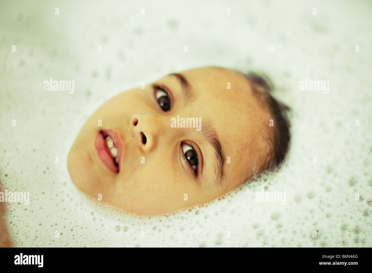 Five year old girl in bubble bath Stock Photo