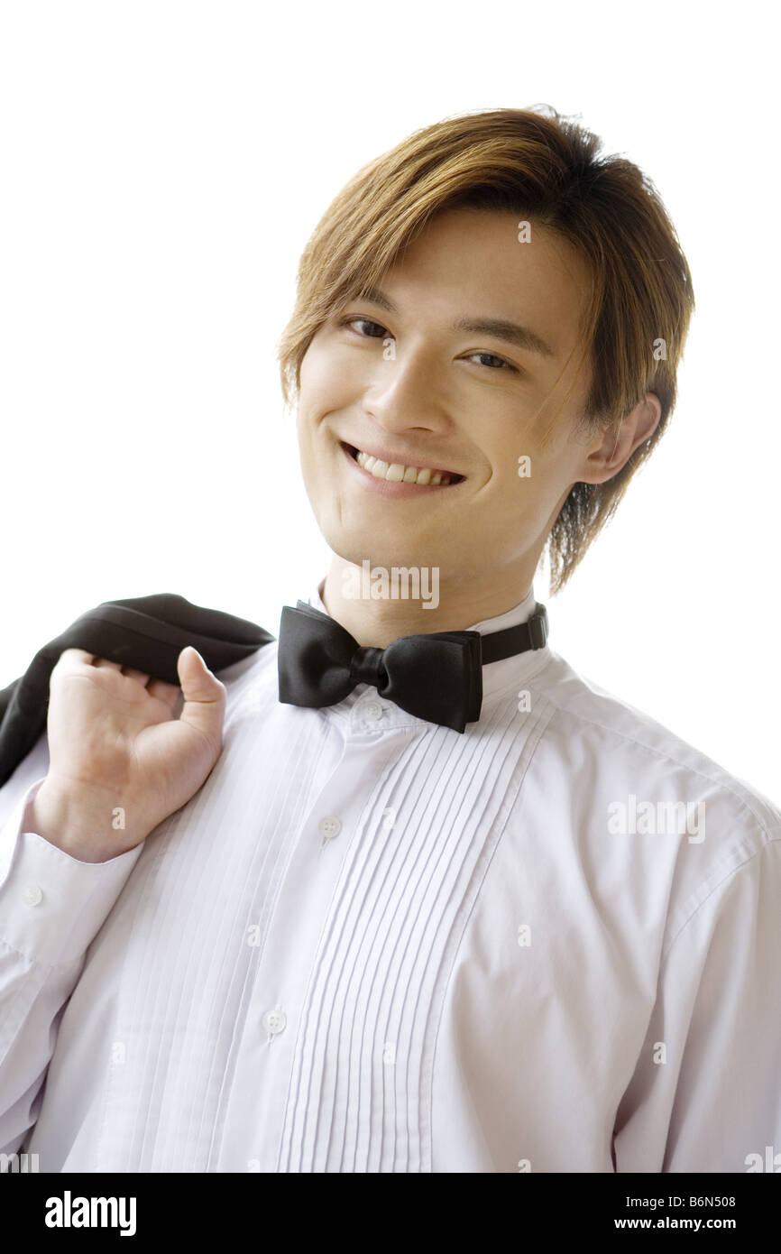 Young groom carrying suit on shoulder smiling portrait Stock Photo - Alamy