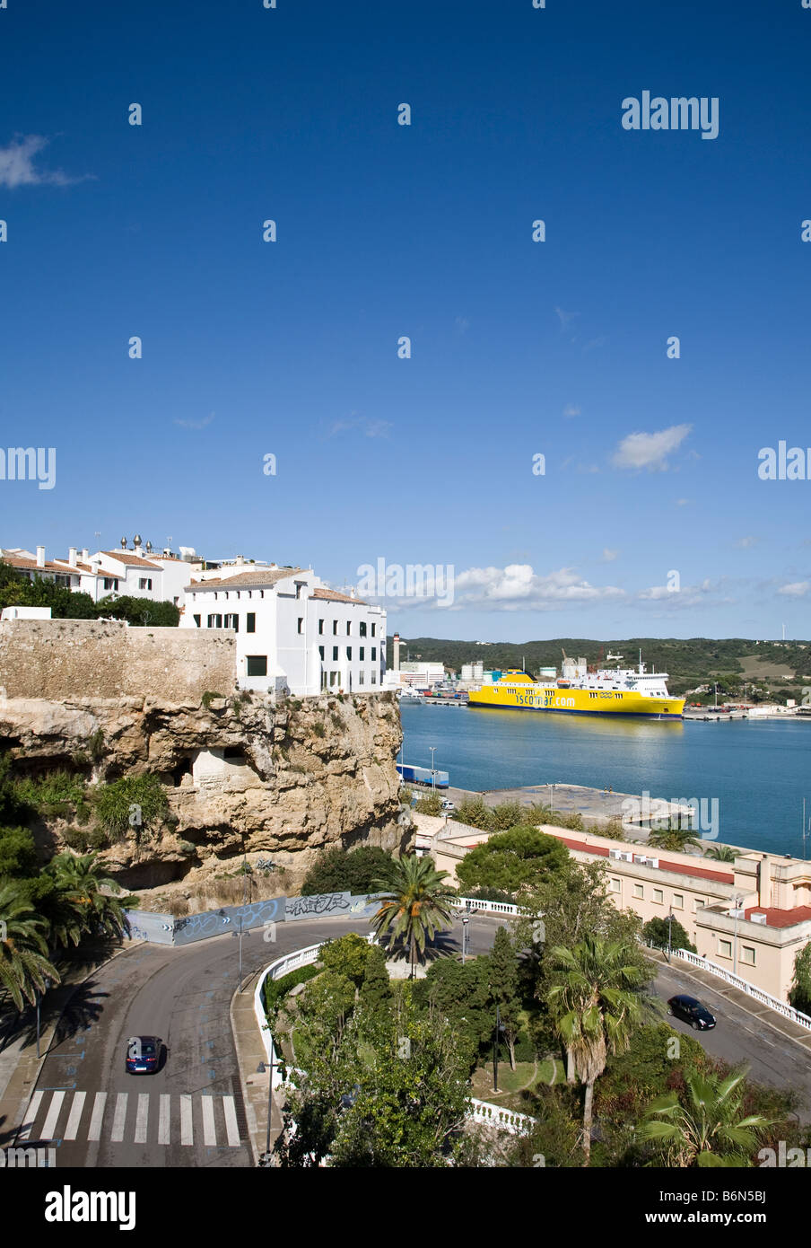 Mao port in Menorca, Spain with an Iscomar ferry loading in the estuary. Stock Photo