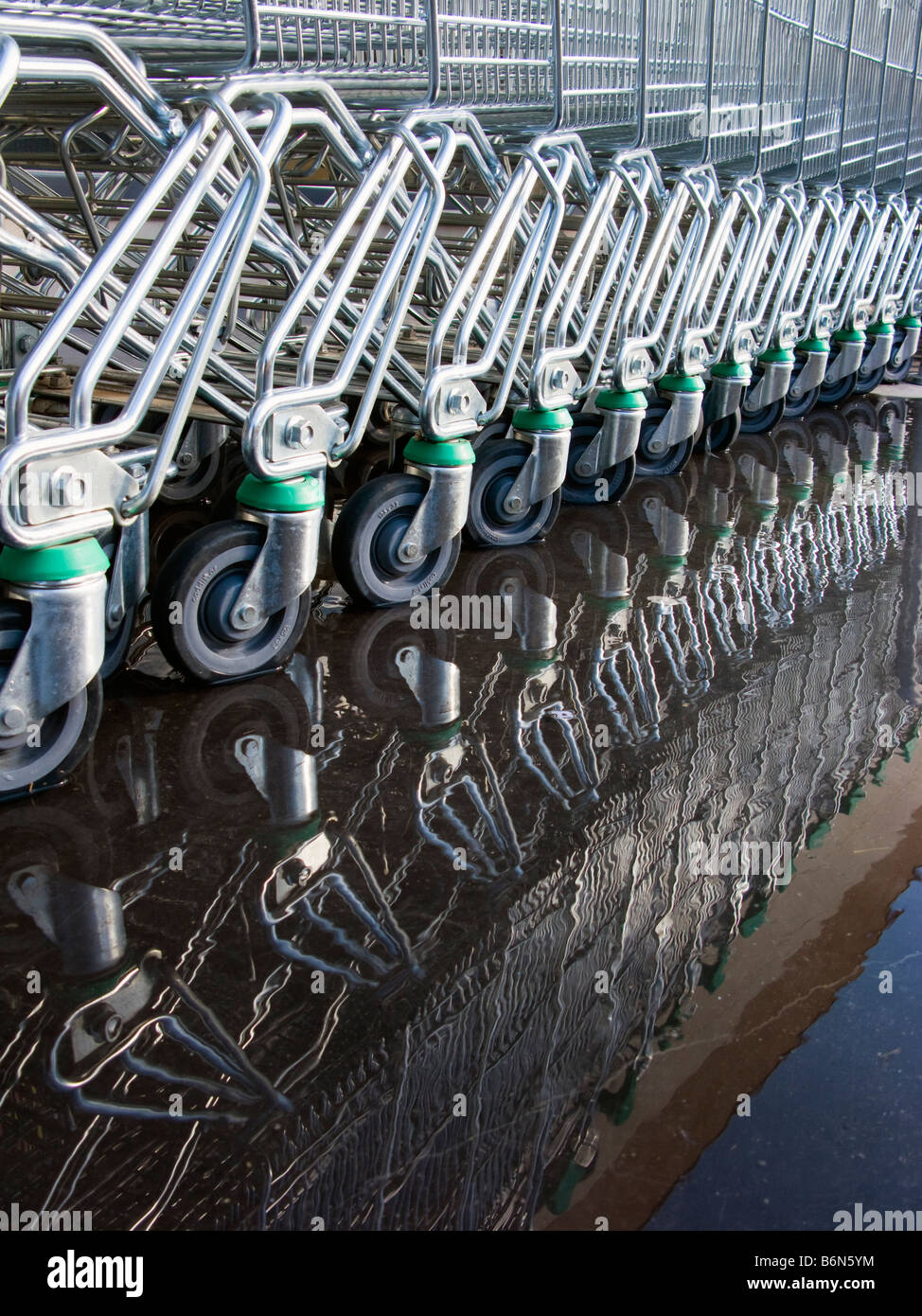 Shopping trolleys parked in puddle Stock Photo