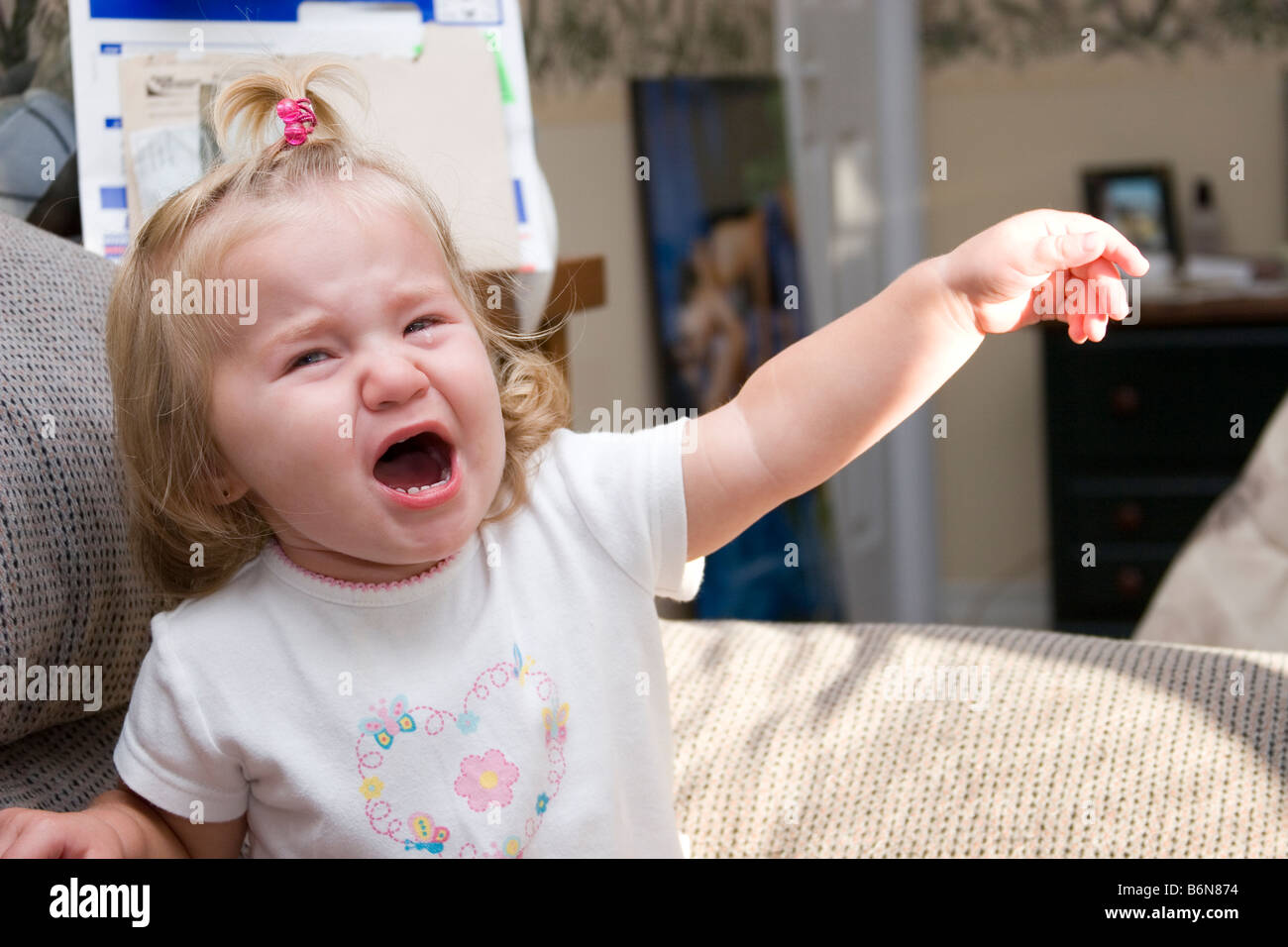 1 to 2 year old toddler girl upset and crying having tantrum Stock