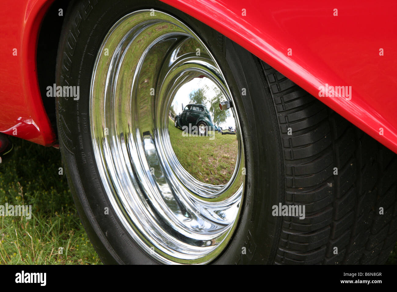 Reflection of one well kept classic car in another. Stock Photo