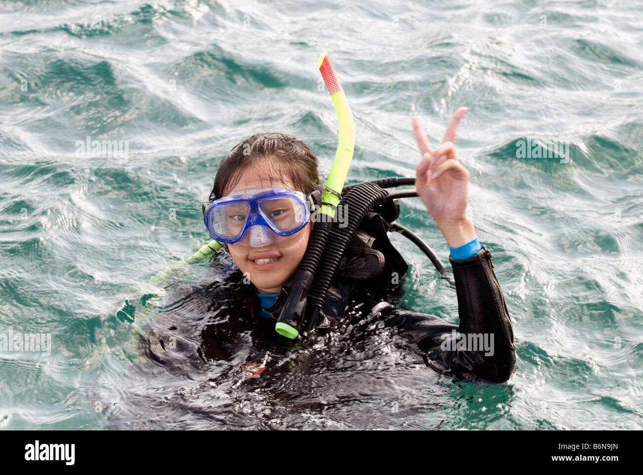 Asian Woman In Scuba Diving Equipment Gesturing The Peace Sign, Taiwan