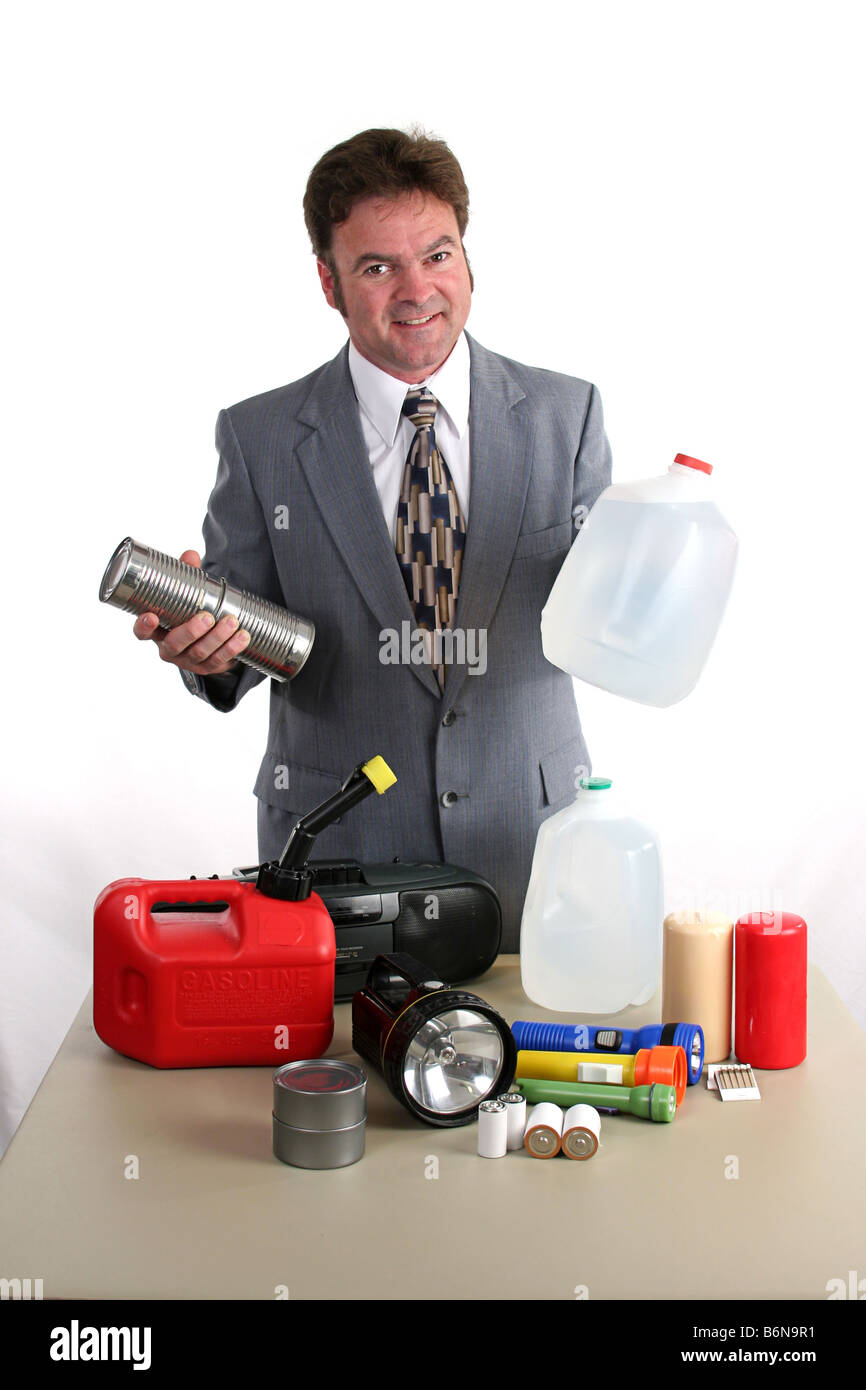 a weatherman showing a hurricane kit and holding up canned food bottled water Stock Photo