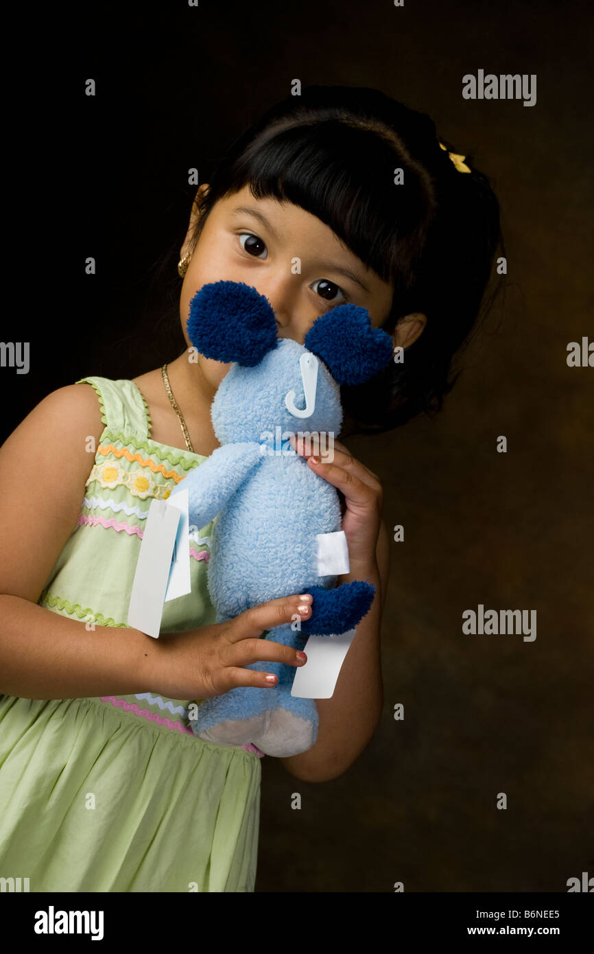 Portrait of a Hispanic girl holding a teddy bear Stock Photo - Alamy