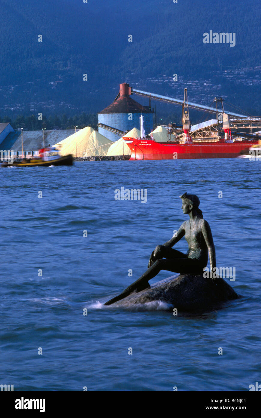 Girl in a Wetsuit Sculpture in Stanley Park and Freighter loading