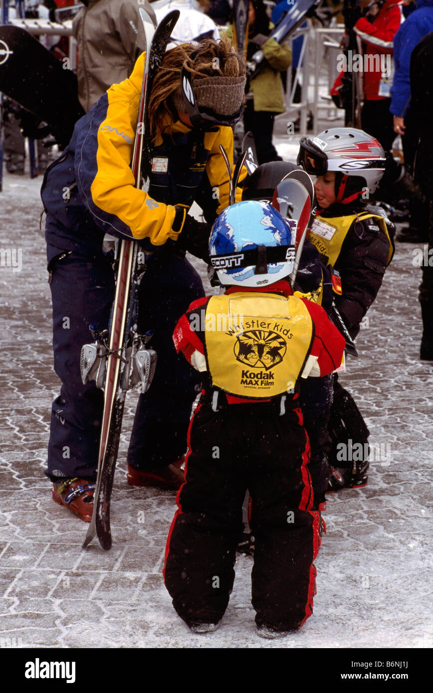 Ski Instructor preparing Young Children for learning to Downhill Ski at