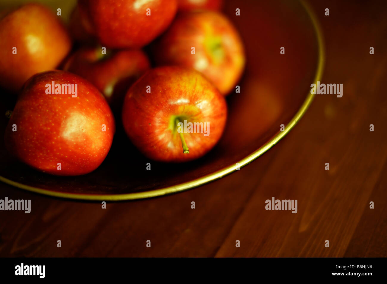 Bowl of apples on table Stock Photo