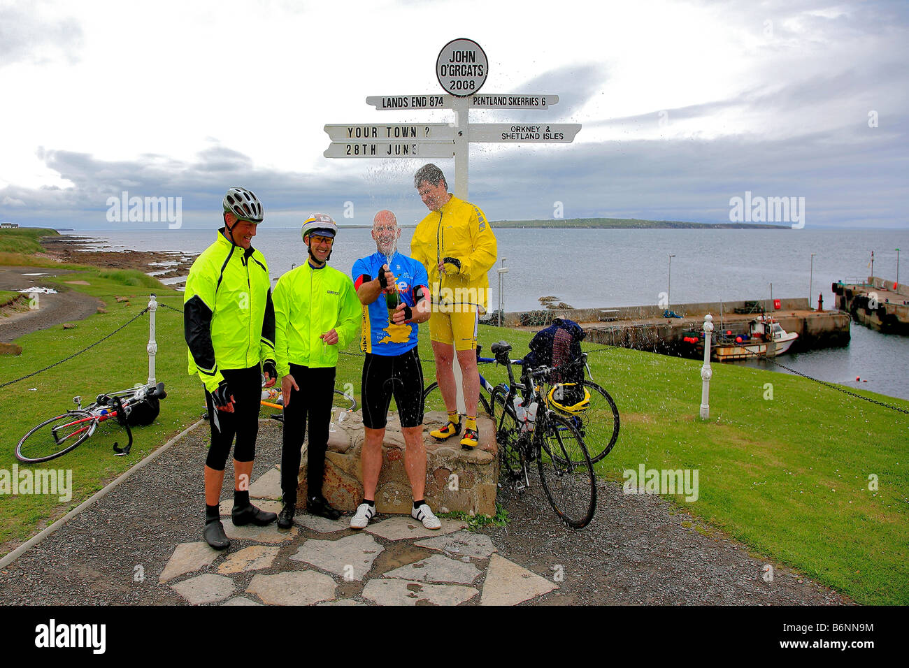 Male Cyclists Celebrating Lands End John O Groats Post End to End Long Distance Cycle Ride Caithness Highlands Scotland UK Stock Photo