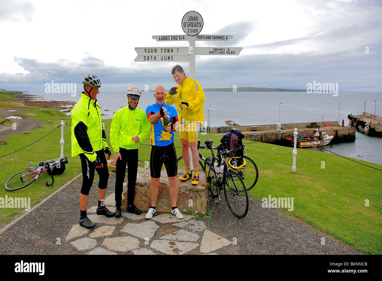 Male Cyclists Celebrating Lands End John O Groats Post End to End Long Distance Cycle Ride Caithness Highlands Scotland UK Stock Photo
