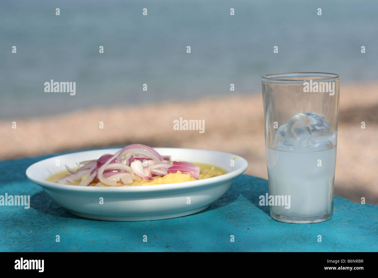 closeup greek traditional food fava with glass of ouzo by the sea with copyspace Stock Photo