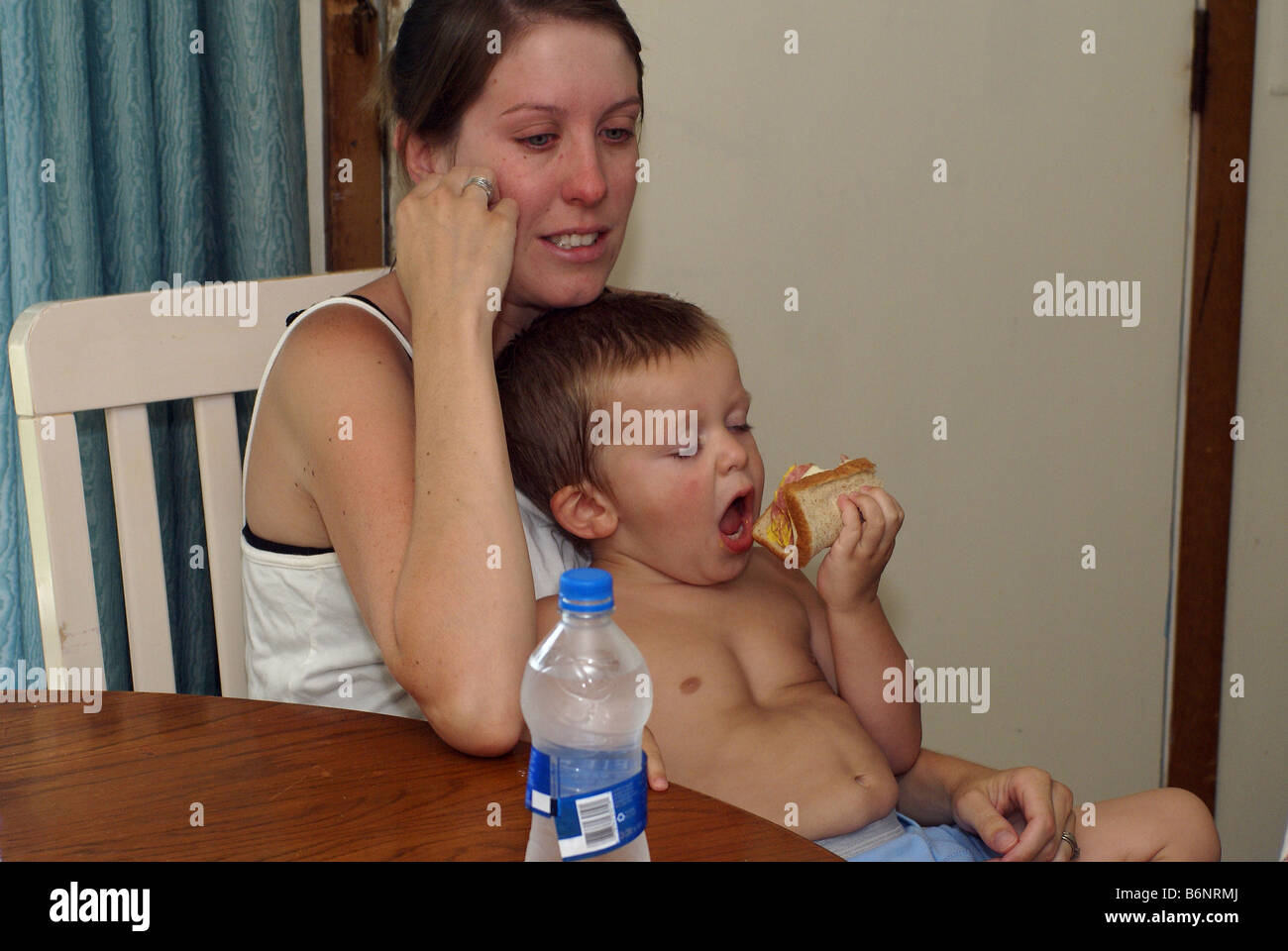 Hungry Child - Tired Mom Stock Photo