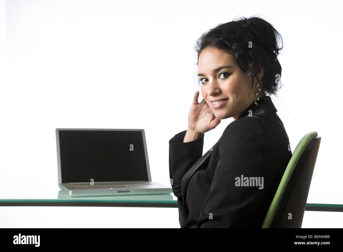 Pretty young businesswoman sitting at her office desk Stock Photo - Alamy