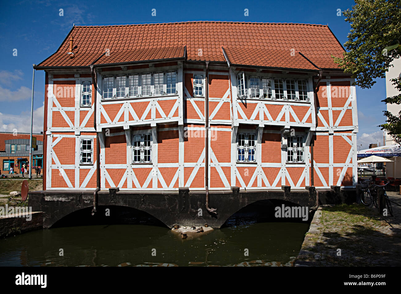 Old style timbered building spanning canal Wismar Germany Stock Photo