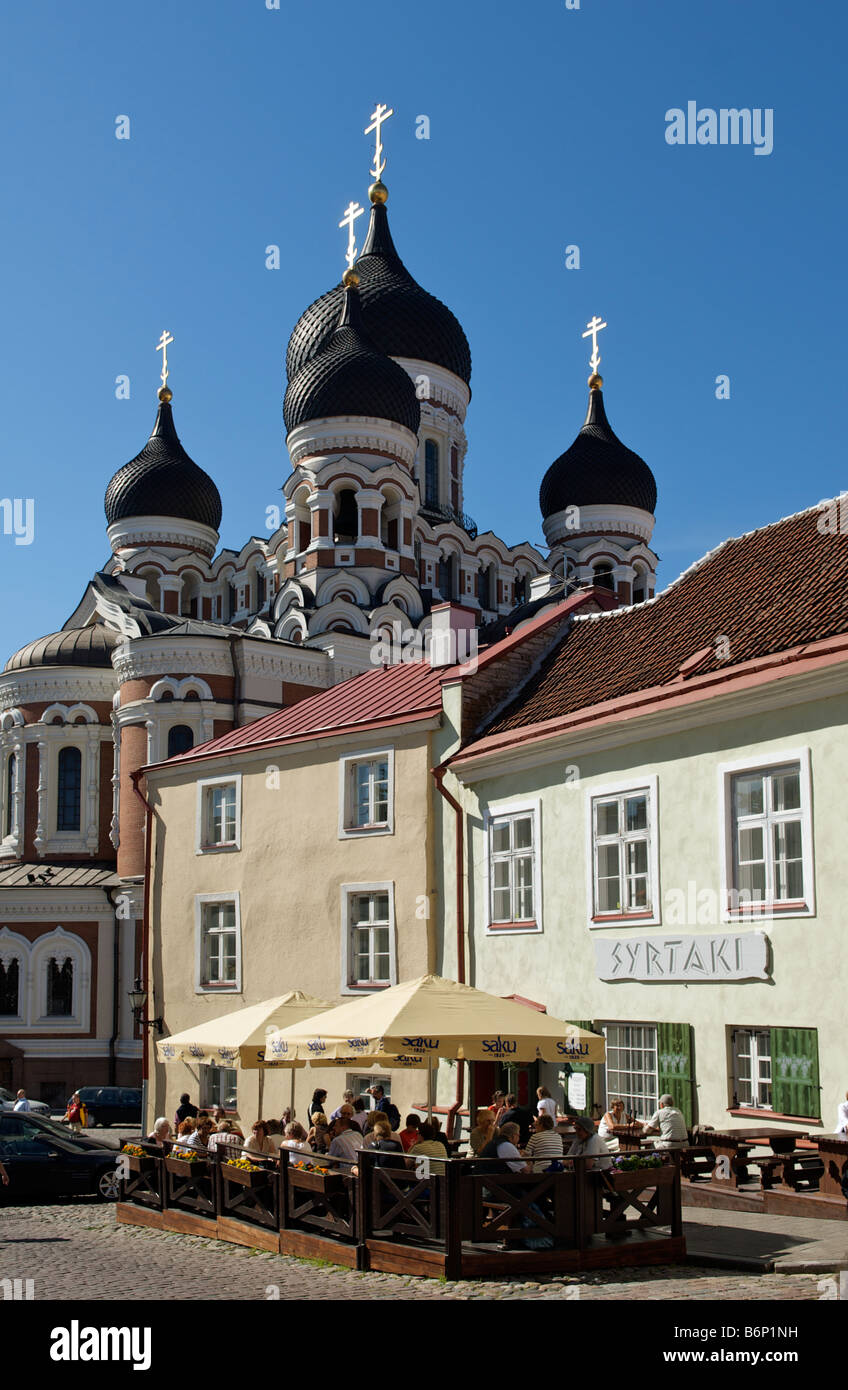 People enjoying eating at a restaurant outside on a summers day with Alexander Nevsky Church in background Tallinn Estonia Stock Photo