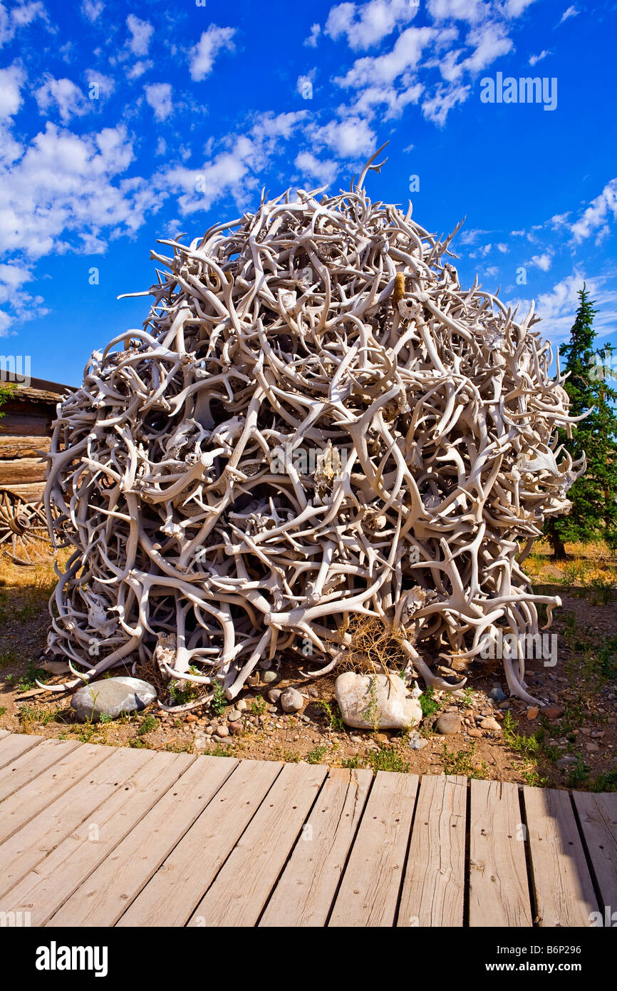Image of a huge pile of deer antlers stacked up between buildings at the Old Trail Town in Cody Wyoming Stock Photo