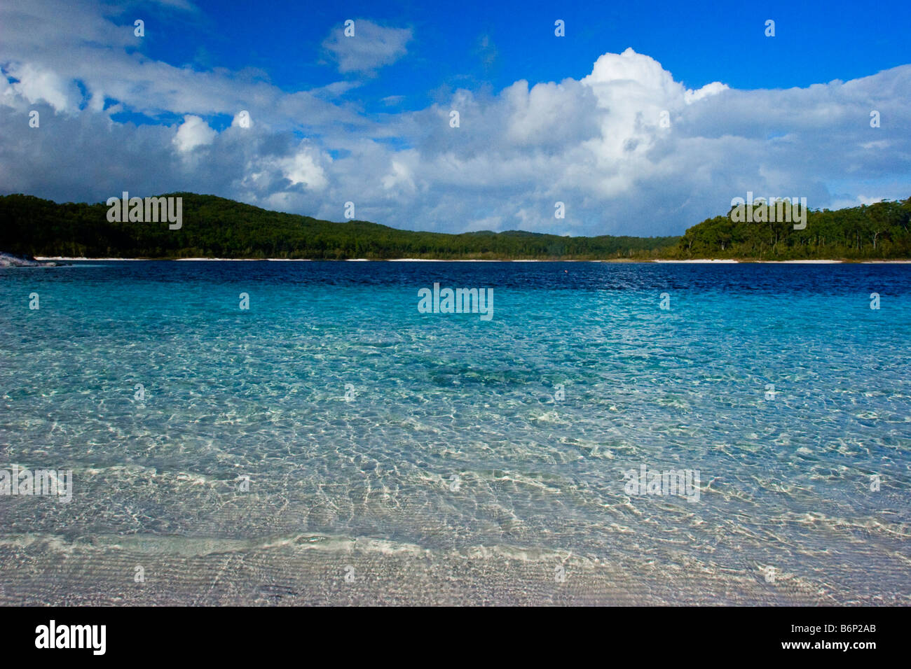 Image looking out across the beautiful white sands and blue waters of Lake McKenzie Fraser Island Australia Stock Photo