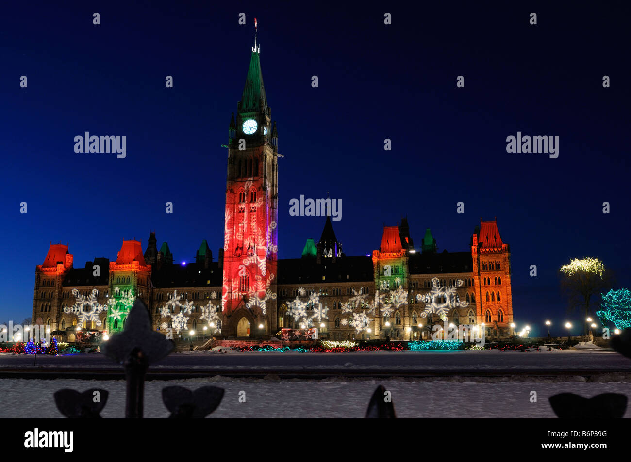 Ottawa Parliament Buildings center block lit by Christmas Lights across  Canada at twilight in winter with snow on Parliament Hill Stock Photo -  Alamy