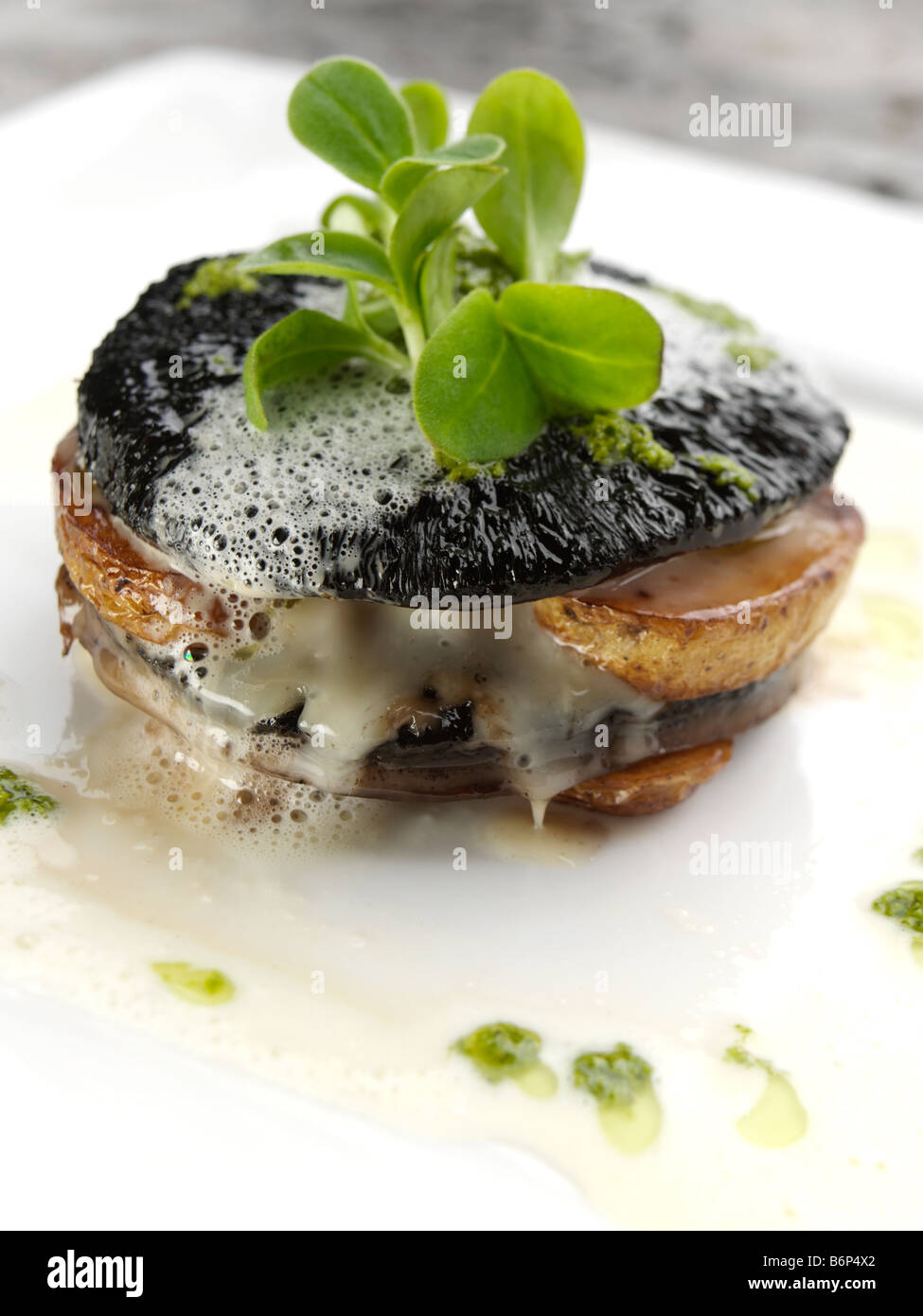 Mushroom stuffed with Stilton and potatoes with Jerusalem artichoke velouta and salsa verde fine dining Stock Photo