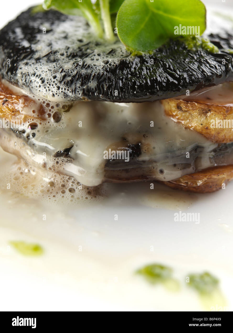 Mushroom stuffed with Stilton and potatoes with Jerusalem artichoke velouta and salsa verde fine dining Stock Photo