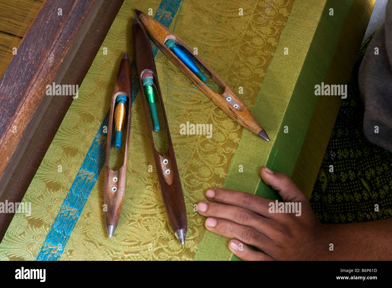 Hand loom, silk bobbins and finished silk sari in an Indian cottage. Andhra Pradesh, India Stock Photo