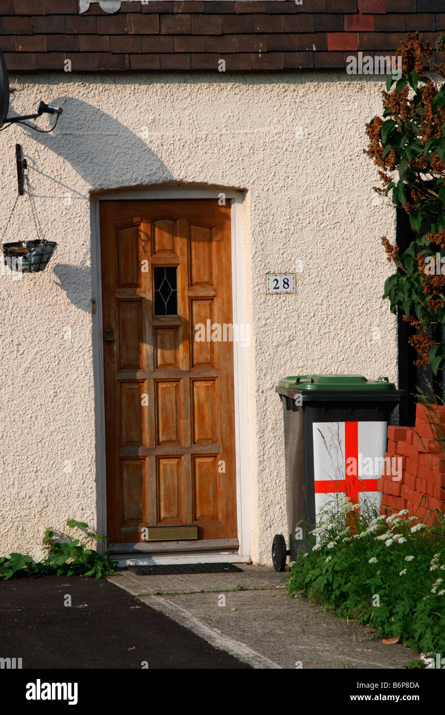 Waterlooville Portsmouth Hampshire UK detail front door ordinary suburban house  wheelie bin painted with red & white cross Stock Photo