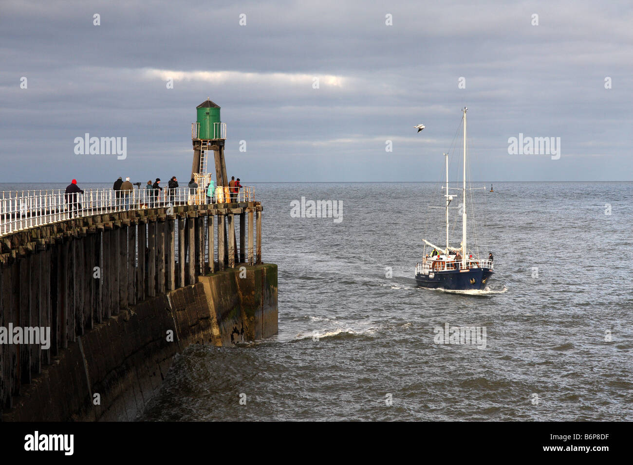 A yacht entering the Whitby harbour in north Yorkshire in England Stock ...