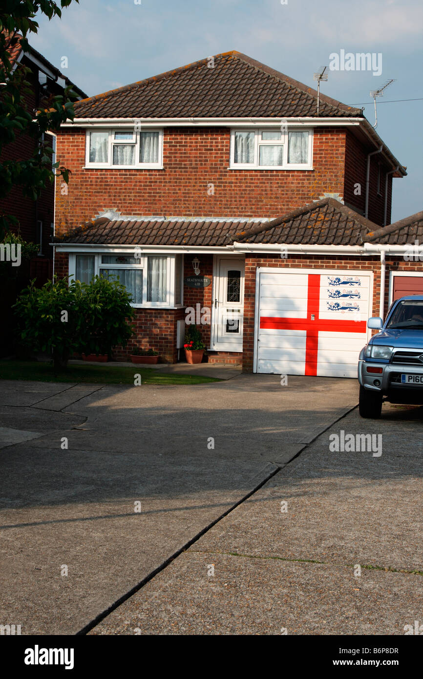 Small detached house Waterlooville, Portsmouth UK. Garage door painted with flag of St George and three lions English football Stock Photo