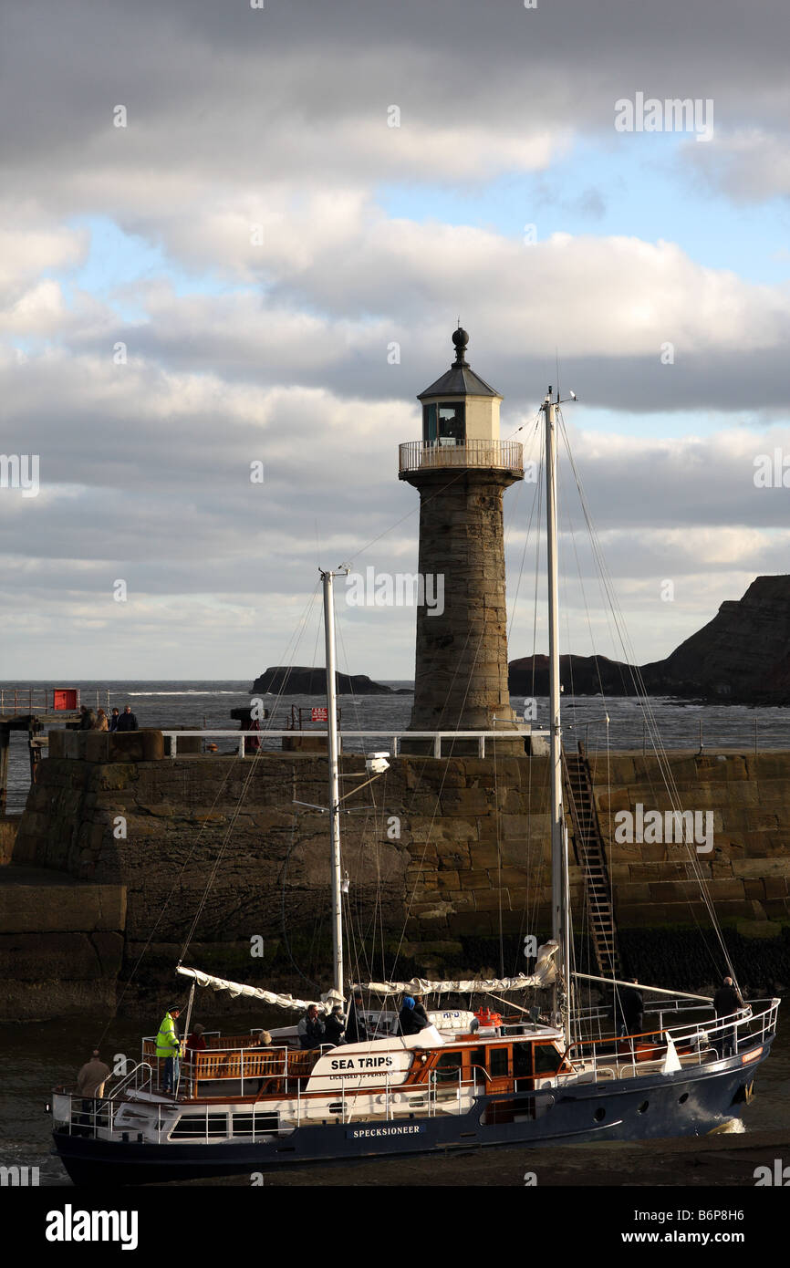 A yacht entering the Whitby harbour in north Yorkshire in England Stock ...