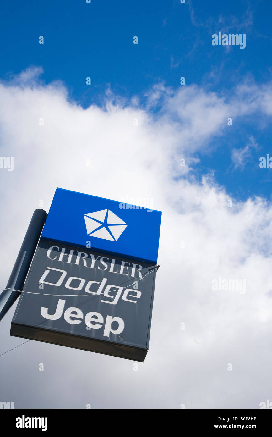 Sign for Chrysler Jeep Dodge against blue sky and white clouds in sunshine Stock Photo