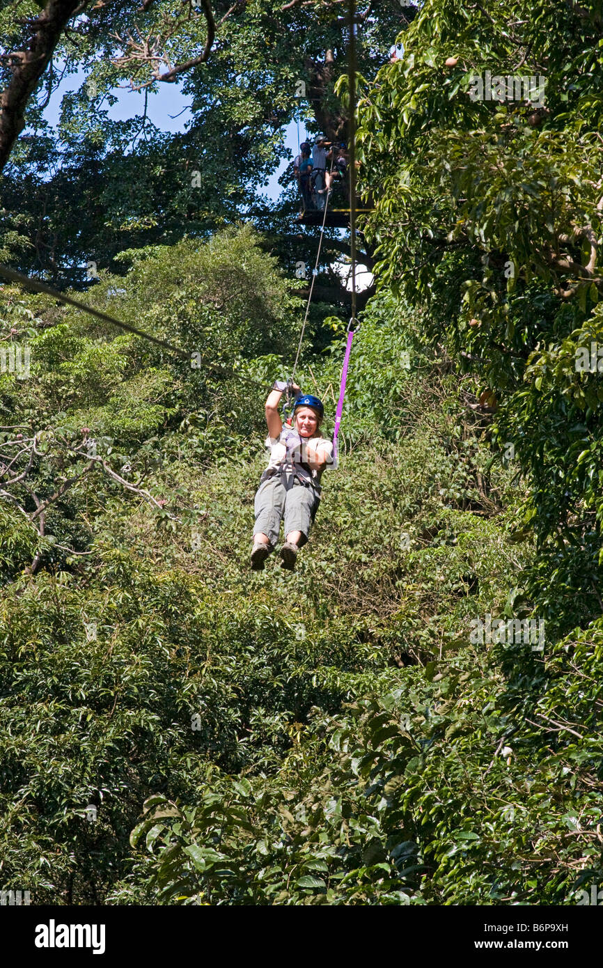 Woman zips through rainforest canopy on zipline tour at Buena Vista ...