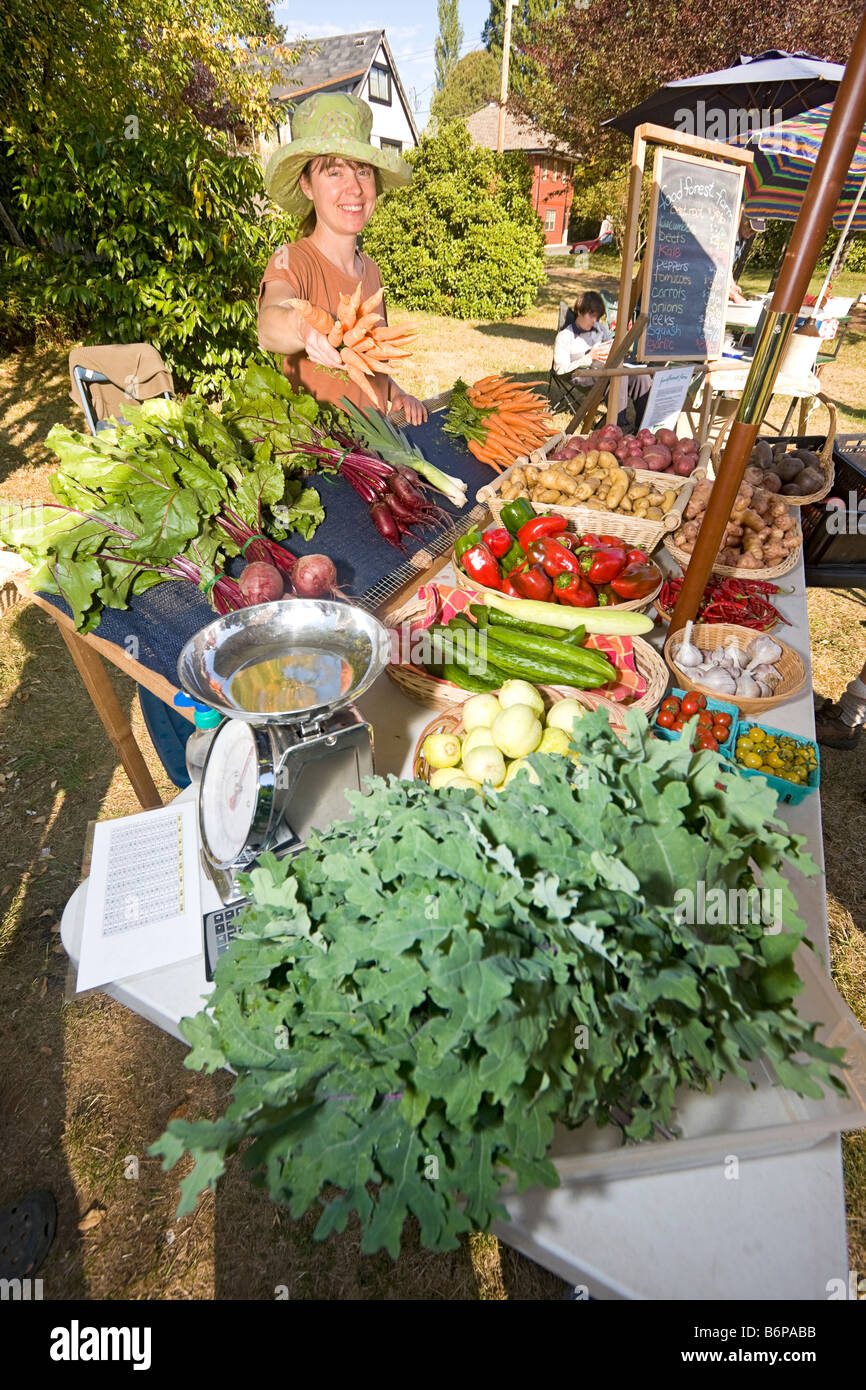 Local farmer sells vegetables at Tuesday market on Salt Spring Island British Columbia Canada. Stock Photo