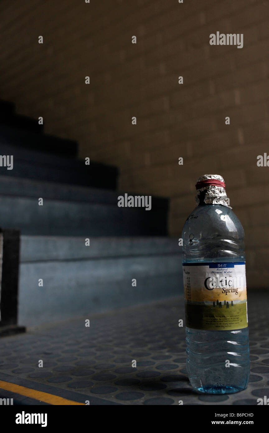 A mineral water bottle especially adapted for the inhalation of crack cocaine smoke. Stock Photo