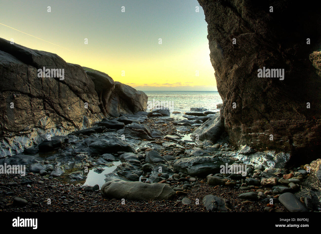 Rocky beach with wet rocks and sea Stock Photo