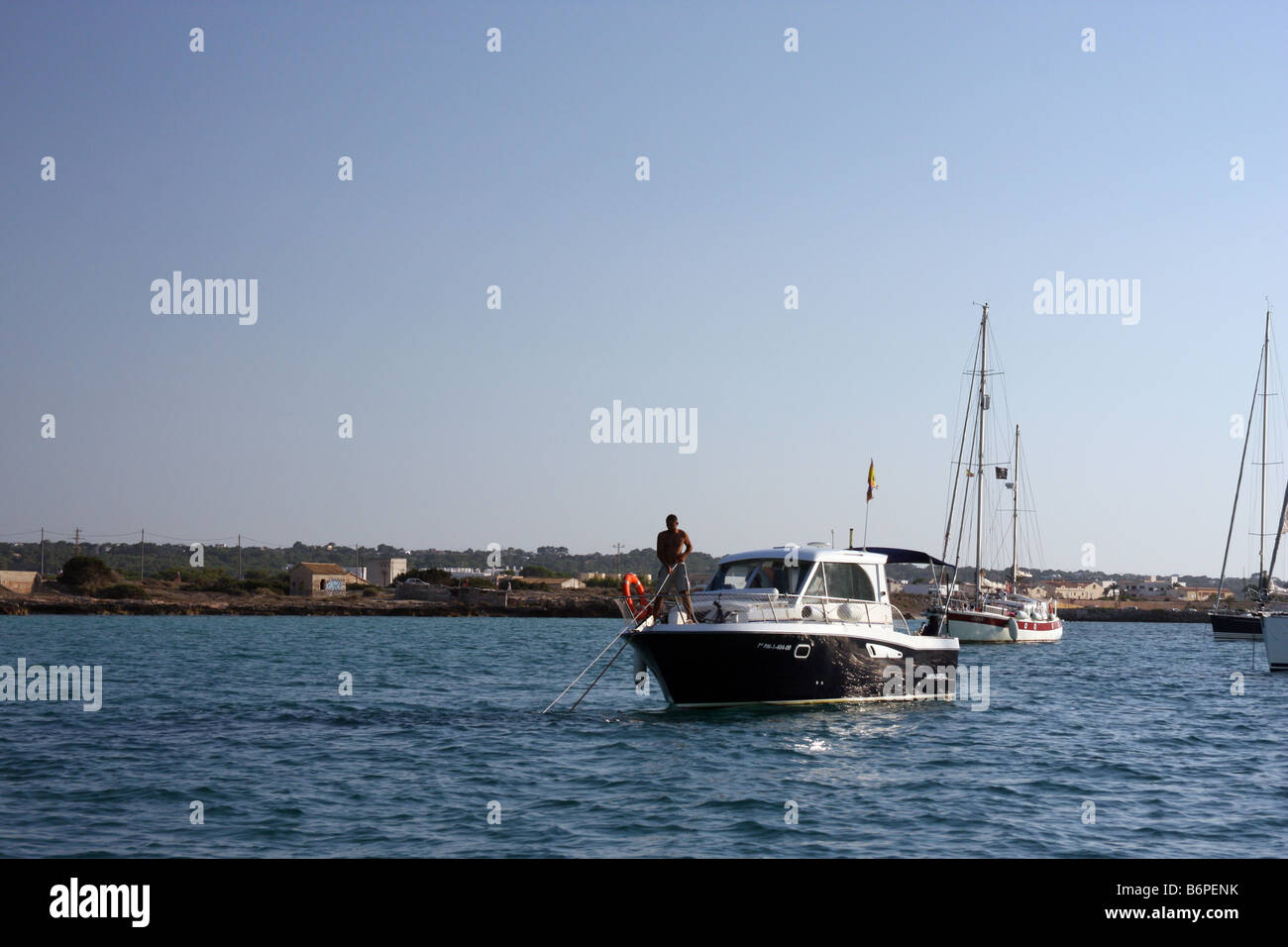 Man weighing anchor in Formentera, Spain Stock Photo