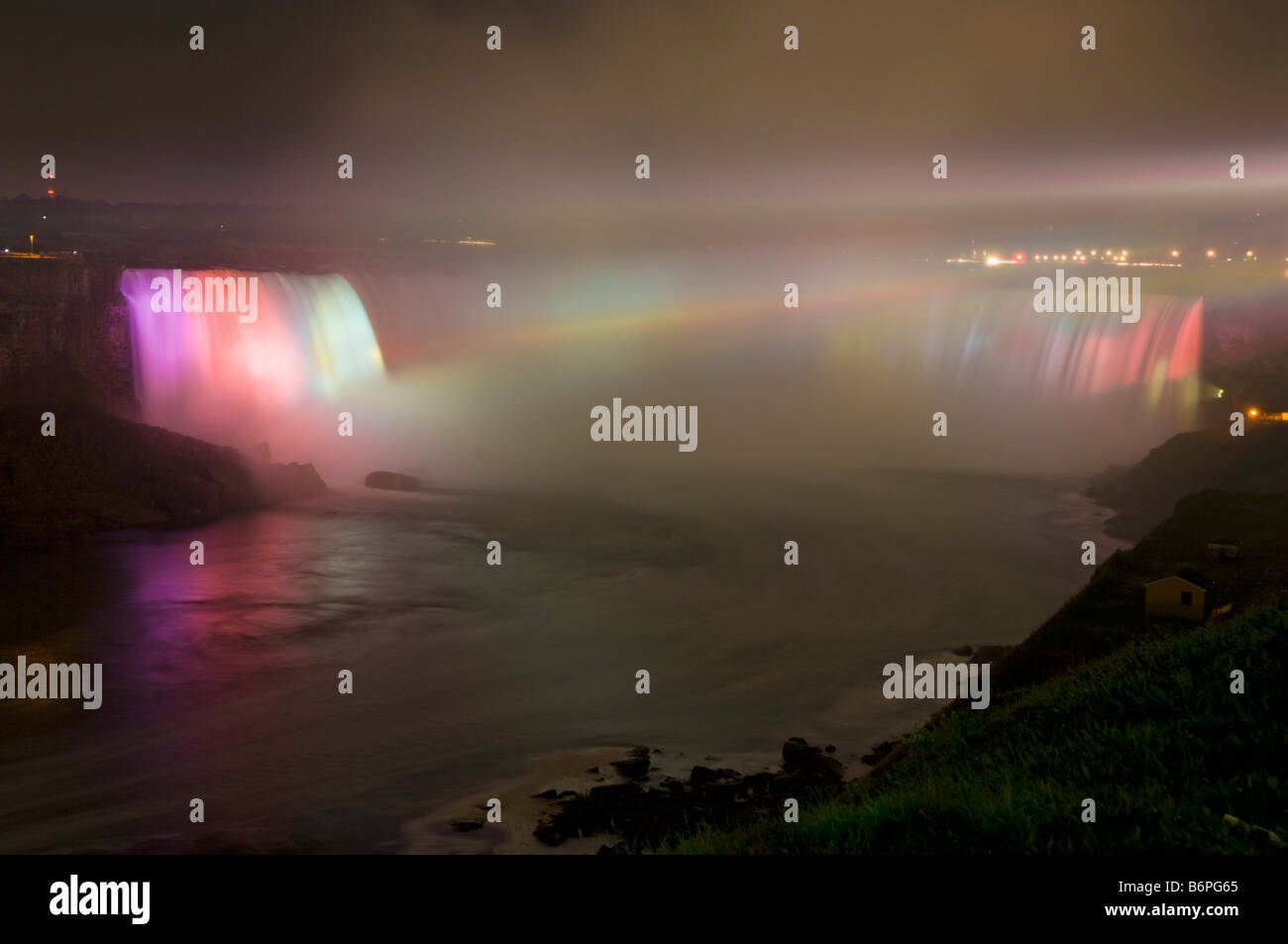 A light show with coloured floodlights at the Horseshoe falls waterfall on the Niagara river Niagara Falls Ontario Canada Stock Photo