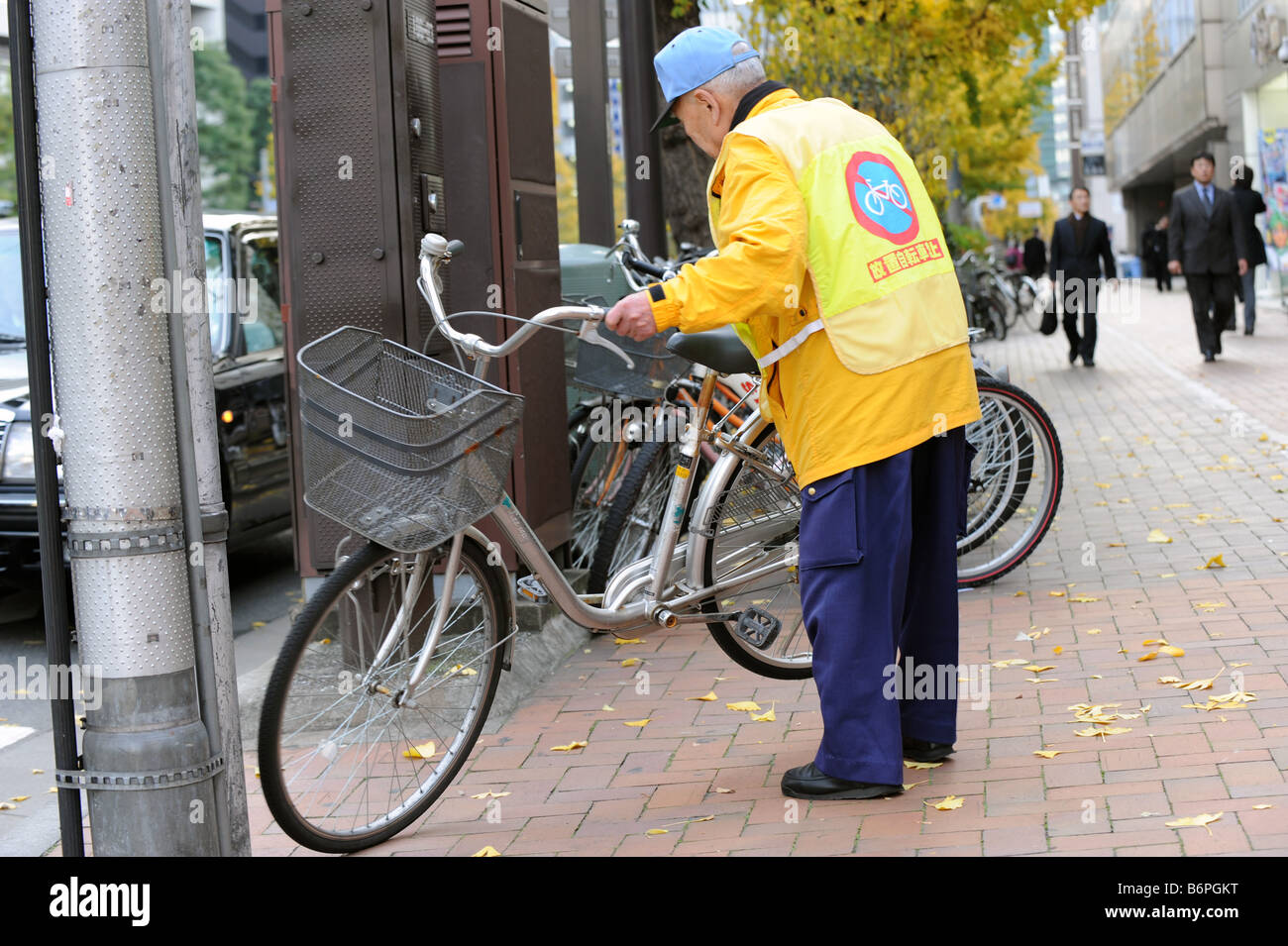 A bicycle parking attendant in Ginza Tokyo Stock Photo