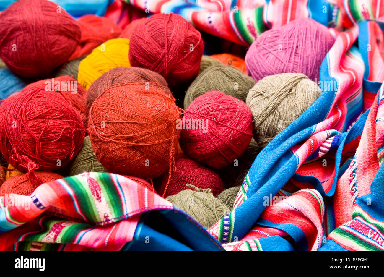 Colourful balls of naturally dyed llama or alpaca wool at Chinchero market Peru South America Stock Photo