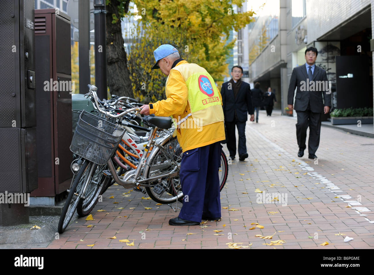 A bicycle parking attendant in Ginza Tokyo Stock Photo