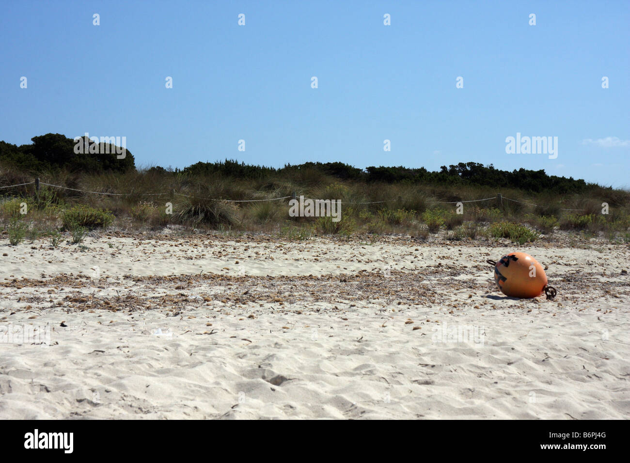 Beached buoy on the sand Stock Photo