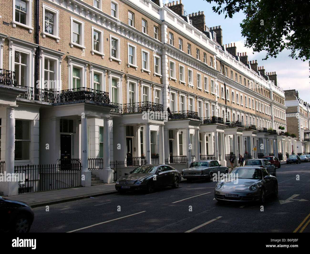 typical South Kensington street with expensive homes and cars London UK